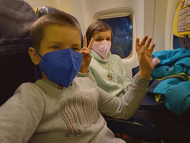 Halyna and her children boarding their flight to the UK